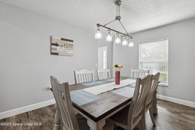 5060 Spinet Dr, Melbourne, FL 32940 - dining space featuring baseboards, dark wood-type flooring, and a textured ceiling