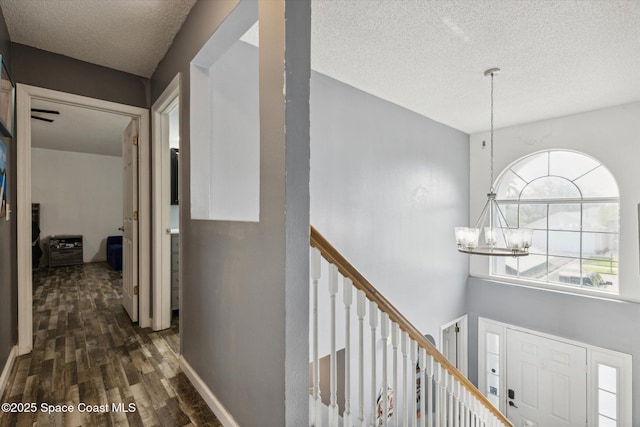 5060 Spinet Dr, Melbourne, FL 32940 - corridor with a textured ceiling, a chandelier, and dark wood-style floors