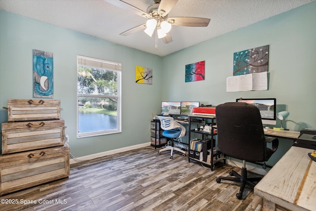 5060 Spinet Dr, Melbourne, FL 32940 - home office with wood finished floors, a ceiling fan, a textured ceiling, and baseboards