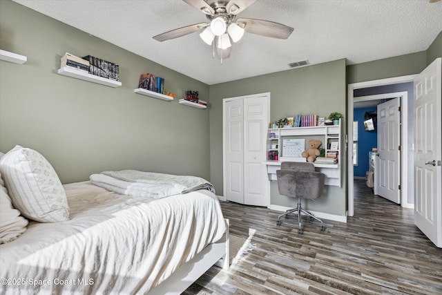 5060 Spinet Dr, Melbourne, FL 32940 - bedroom featuring wood finished floors, a closet, a textured ceiling, a ceiling fan, and baseboards