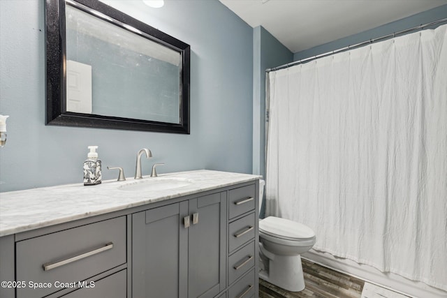 5060 Spinet Dr, Melbourne, FL 32940 - bathroom featuring vanity, toilet, wood finished floors, and curtained shower