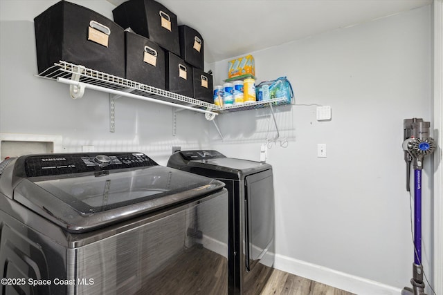 5060 Spinet Dr, Melbourne, FL 32940 - washroom with washer and dryer, wood finished floors, and baseboards
