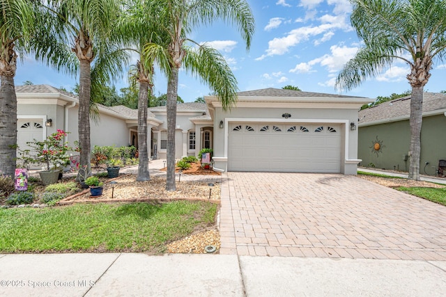 2009 Tullagee Ave, Melbourne, FL 32940 - ranch-style house with stucco siding, decorative driveway, and a garage