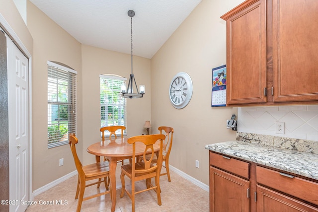 2009 Tullagee Ave, Melbourne, FL 32940 - dining area featuring baseboards, light tile patterned floors, and a chandelier