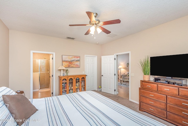 2009 Tullagee Ave, Melbourne, FL 32940 - carpeted bedroom with baseboards, a ceiling fan, a textured ceiling, and ensuite bathroom