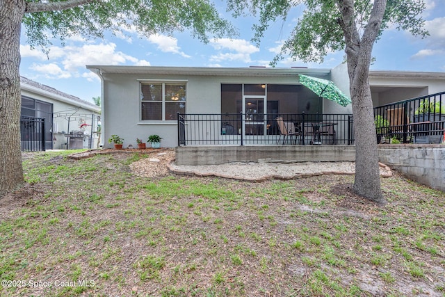 2009 Tullagee Ave, Melbourne, FL 32940 - rear view of house with stucco siding and a sunroom