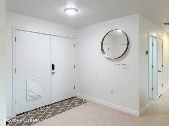 234 Micanopy Ct, Indian Harbour Beach, FL 32937 - entryway featuring baseboards and a textured ceiling