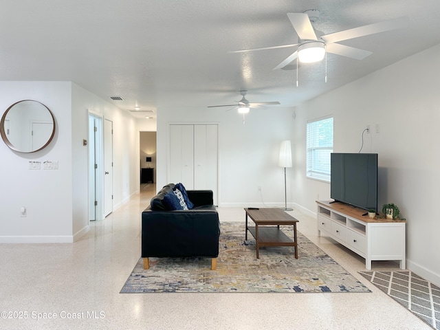 234 Micanopy Ct, Indian Harbour Beach, FL 32937 - living room featuring a ceiling fan, speckled floor, and baseboards