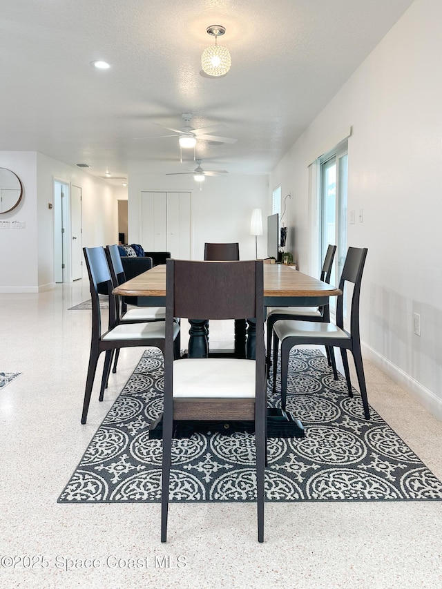 234 Micanopy Ct, Indian Harbour Beach, FL 32937 - dining area featuring ceiling fan, baseboards, and dark aggregate flooring