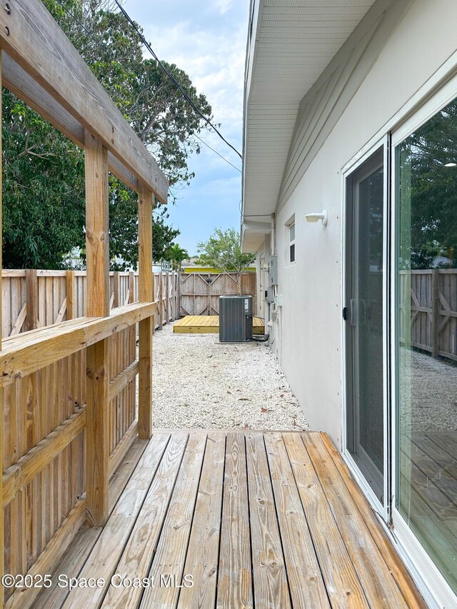 234 Micanopy Ct, Indian Harbour Beach, FL 32937 - wooden deck featuring central AC and a fenced backyard