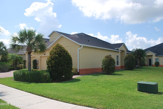 5908 Van Ness Dr, Melbourne, FL 32940 - view of home's exterior featuring stucco siding, a yard, a garage, and driveway