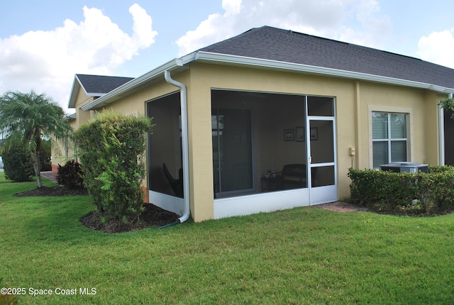 5908 Van Ness Dr, Melbourne, FL 32940 - rear view of property featuring stucco siding, a lawn, and roof with shingles