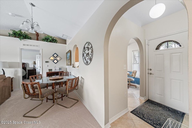 1776 Sawgrass Dr SW, Palm Bay, FL 32908 - foyer entrance featuring arched walkways, a chandelier, lofted ceiling, and baseboards