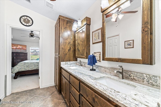 1776 Sawgrass Dr SW, Palm Bay, FL 32908 - bathroom featuring a ceiling fan, connected bathroom, double vanity, tile patterned floors, and baseboards