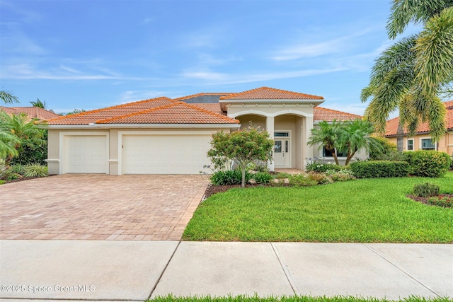 3360 Thurloe Dr, Rockledge, FL 32955 - mediterranean / spanish-style house with decorative driveway, stucco siding, a front lawn, and an attached garage