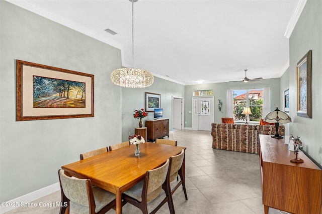 3360 Thurloe Dr, Rockledge, FL 32955 - dining space featuring ornamental molding, light tile patterned flooring, baseboards, ceiling fan, and a chandelier