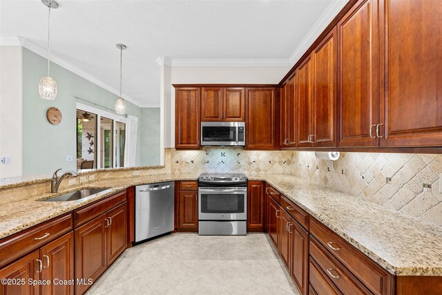 3360 Thurloe Dr, Rockledge, FL 32955 - kitchen featuring stainless steel appliances, a sink, light stone counters, hanging light fixtures, and ornamental molding