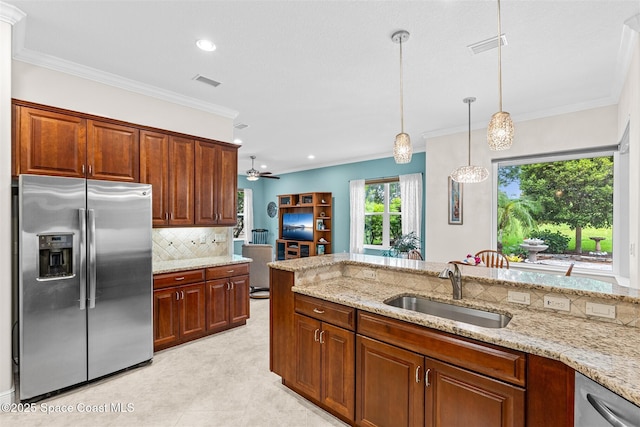 3360 Thurloe Dr, Rockledge, FL 32955 - kitchen with appliances with stainless steel finishes, a sink, decorative backsplash, light stone counters, and hanging light fixtures