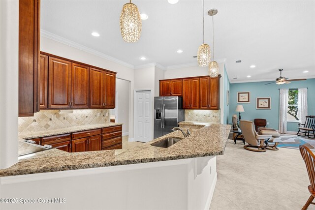 3360 Thurloe Dr, Rockledge, FL 32955 - kitchen featuring a sink, stainless steel refrigerator with ice dispenser, recessed lighting, light stone countertops, and tasteful backsplash