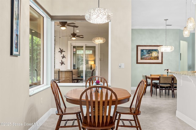 3360 Thurloe Dr, Rockledge, FL 32955 - dining area featuring a chandelier, baseboards, a ceiling fan, and crown molding
