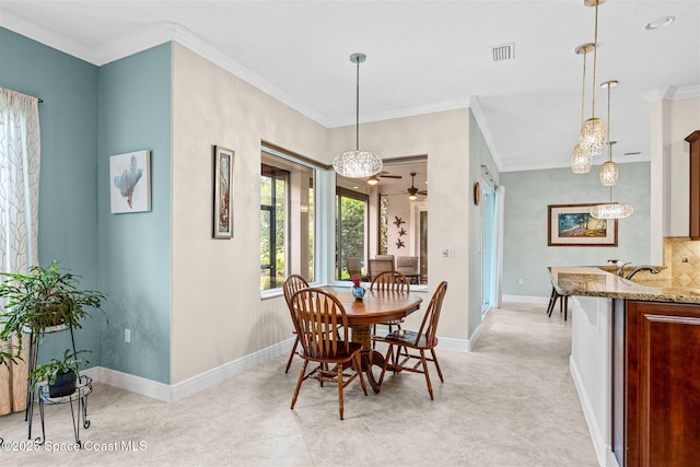 3360 Thurloe Dr, Rockledge, FL 32955 - dining space featuring crown molding, baseboards, and ceiling fan