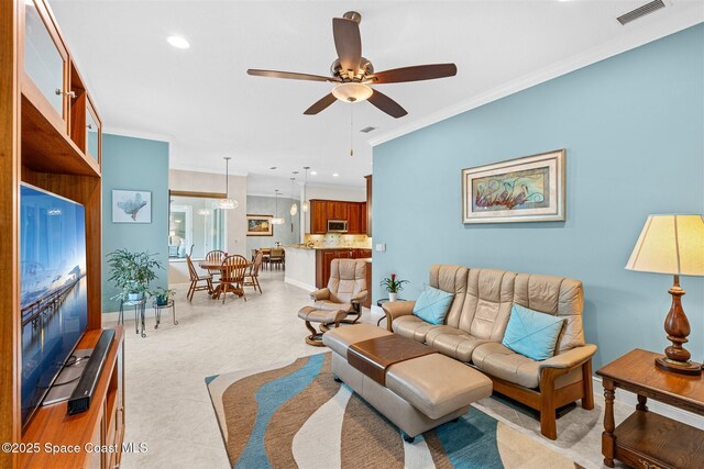 3360 Thurloe Dr, Rockledge, FL 32955 - living area featuring a ceiling fan, crown molding, recessed lighting, and baseboards