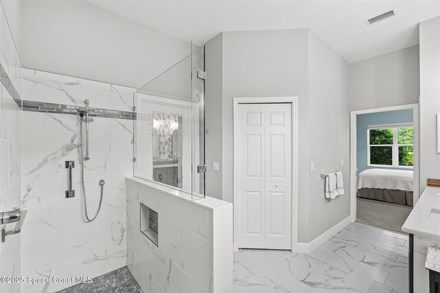3360 Thurloe Dr, Rockledge, FL 32955 - ensuite bathroom featuring marble finish floors, a marble finish shower, baseboards, and vanity