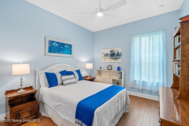 3360 Thurloe Dr, Rockledge, FL 32955 - bedroom with hardwood / wood-style flooring, baseboards, and a ceiling fan