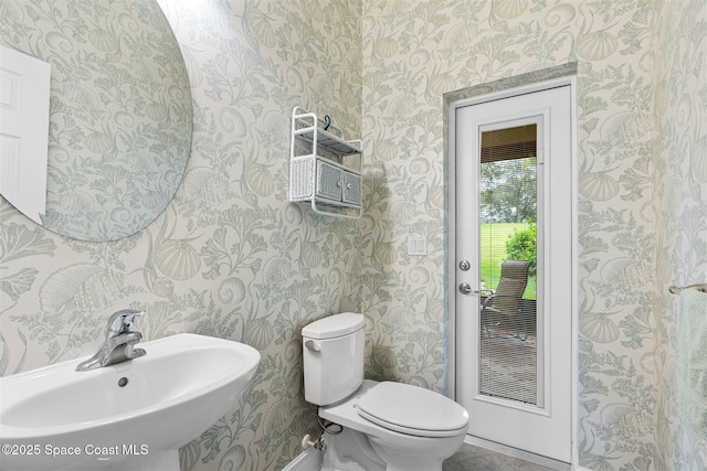3360 Thurloe Dr, Rockledge, FL 32955 - half bath with wallpapered walls, a sink, toilet, and baseboards