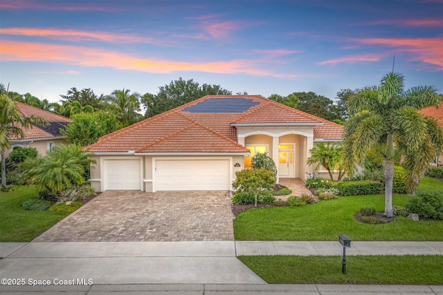 3360 Thurloe Dr, Rockledge, FL 32955 - mediterranean / spanish home featuring a tile roof, stucco siding, driveway, a yard, and an attached garage