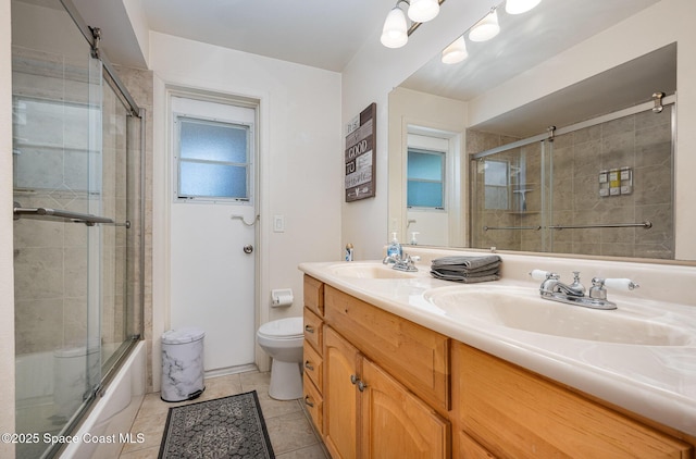 1505 W Central Ave, Merritt Island, FL 32952 - full bath featuring double vanity, toilet, tile patterned flooring, and shower / bath combination with glass door