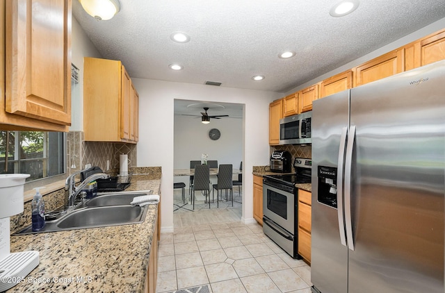 1505 W Central Ave, Merritt Island, FL 32952 - kitchen with stainless steel appliances, a ceiling fan, tasteful backsplash, recessed lighting, and a sink