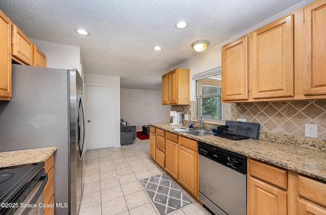1505 W Central Ave, Merritt Island, FL 32952 - kitchen with stainless steel dishwasher, a sink, decorative backsplash, a textured ceiling, and light tile patterned floors