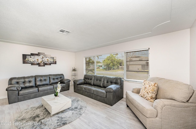 1505 W Central Ave, Merritt Island, FL 32952 - living room featuring light wood finished floors and a textured ceiling