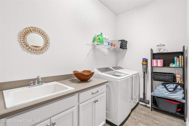 3039 Avalonia Dr, Melbourne, FL 32940 - laundry room featuring washer and dryer, light wood-style flooring, and cabinet space