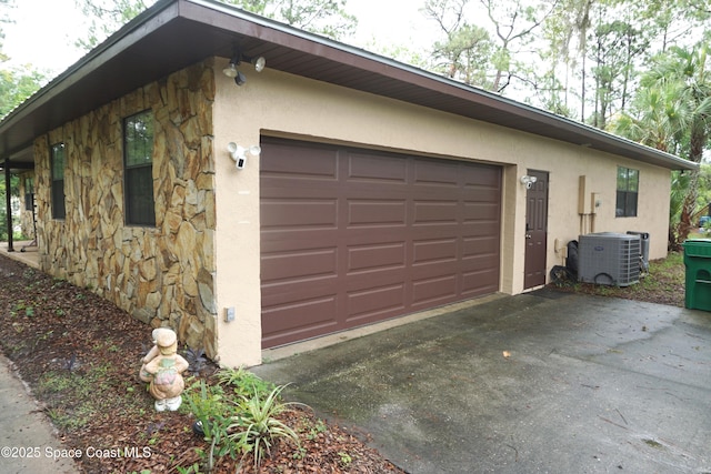 7001 Windover Way, Titusville, FL 32780 - view of side of home with stone siding, stucco siding, asphalt driveway, and an attached garage
