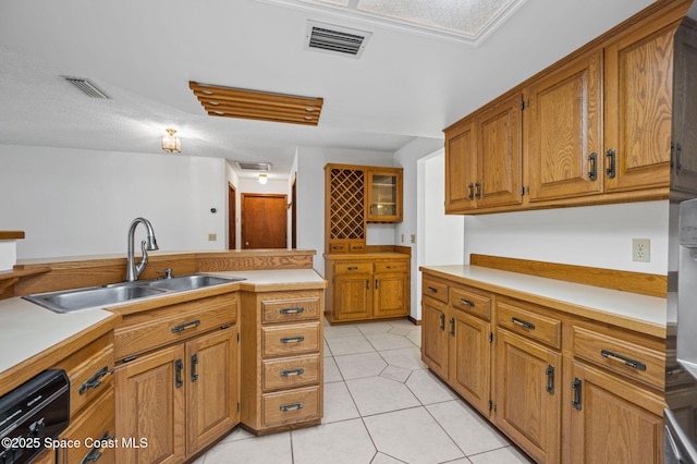 7001 Windover Way, Titusville, FL 32780 - kitchen featuring brown cabinetry, light countertops, light tile patterned flooring, and dishwashing machine