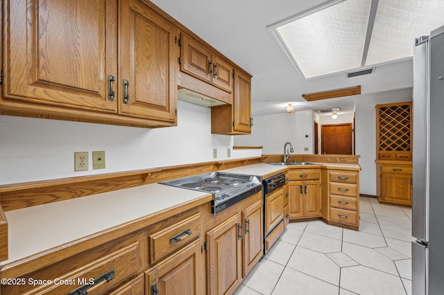 7001 Windover Way, Titusville, FL 32780 - kitchen with appliances with stainless steel finishes, a peninsula, light tile patterned flooring, light countertops, and brown cabinets