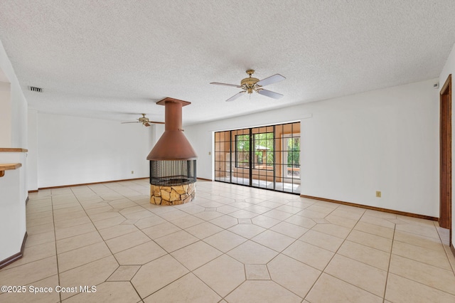 7001 Windover Way, Titusville, FL 32780 - unfurnished living room with ceiling fan, a textured ceiling, light tile patterned floors, and a wood stove