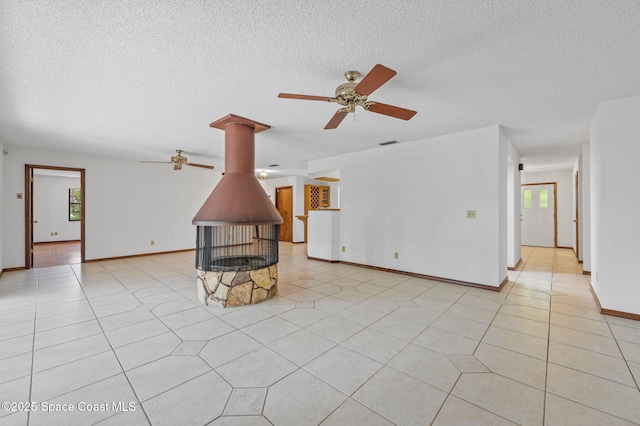 7001 Windover Way, Titusville, FL 32780 - unfurnished living room with a ceiling fan, healthy amount of natural light, a textured ceiling, and light tile patterned floors