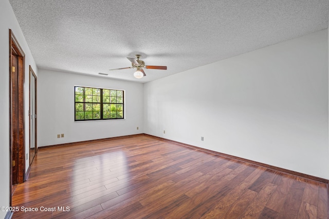 7001 Windover Way, Titusville, FL 32780 - empty room with wood finished floors, ceiling fan, and a textured ceiling