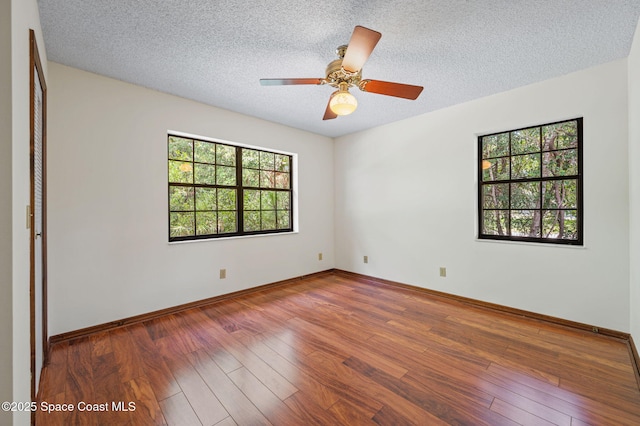 7001 Windover Way, Titusville, FL 32780 - spare room with wood finished floors, a textured ceiling, and a ceiling fan