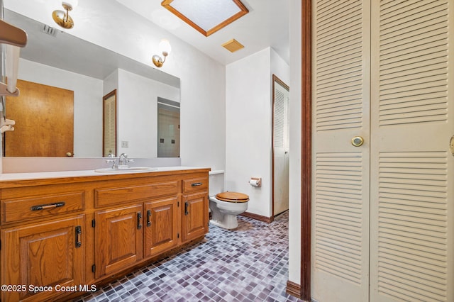 7001 Windover Way, Titusville, FL 32780 - bathroom featuring vanity, a closet, and brick patterned flooring