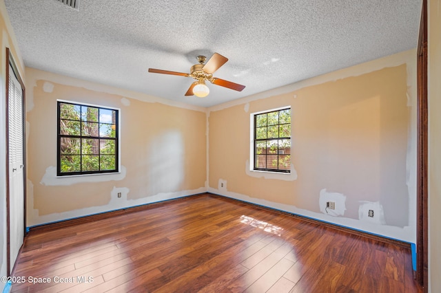 7001 Windover Way, Titusville, FL 32780 - empty room with hardwood / wood-style flooring, a textured ceiling, and ceiling fan