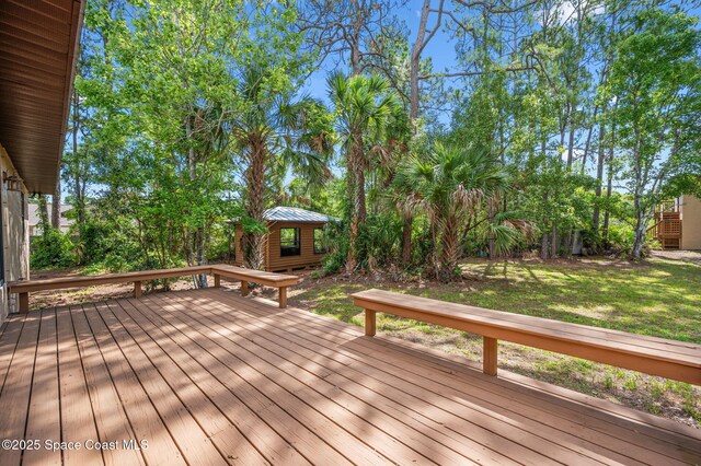 7001 Windover Way, Titusville, FL 32780 - wooden deck featuring an outdoor structure and a lawn