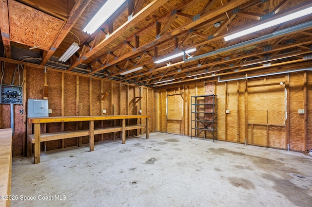 7001 Windover Way, Titusville, FL 32780 - garage featuring electric panel and a workshop area