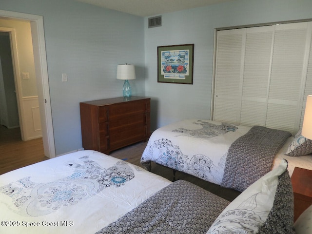 504 Fillmore Ave Unit B-8, Cape Canaveral, FL 32920 - bedroom featuring wood finished floors and a closet