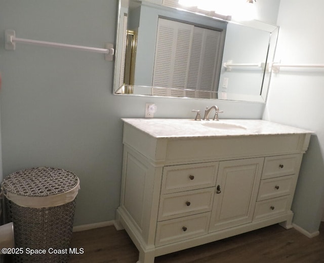 504 Fillmore Ave Unit B-8, Cape Canaveral, FL 32920 - bathroom with wood finished floors, vanity, and baseboards