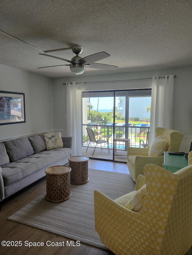 504 Fillmore Ave Unit B-8, Cape Canaveral, FL 32920 - living room with wood finished floors, ceiling fan, and a textured ceiling