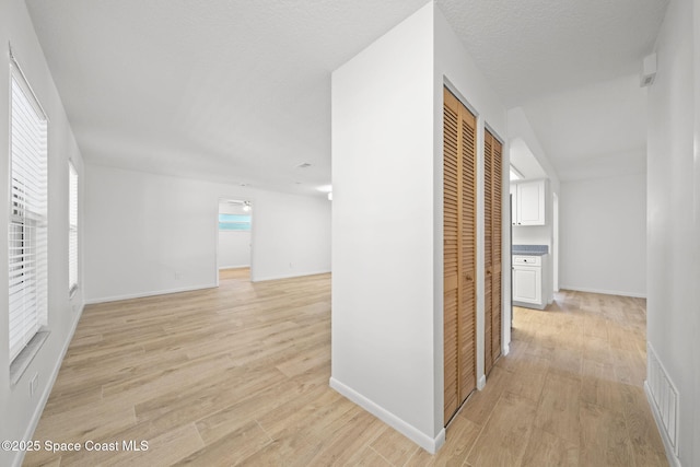 2036 Hogan Dr, Melbourne, FL 32935 - hallway with light wood-style flooring and baseboards